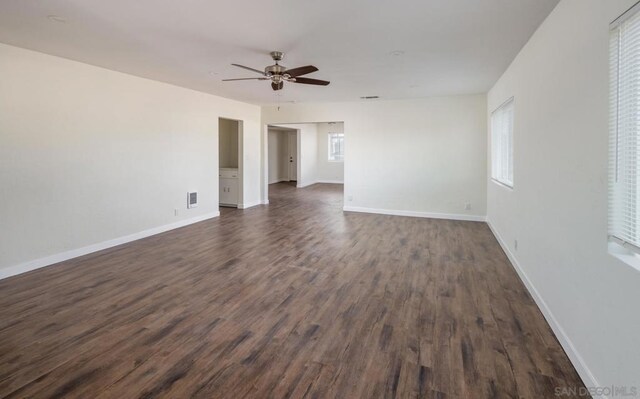 empty room featuring dark wood-type flooring and ceiling fan