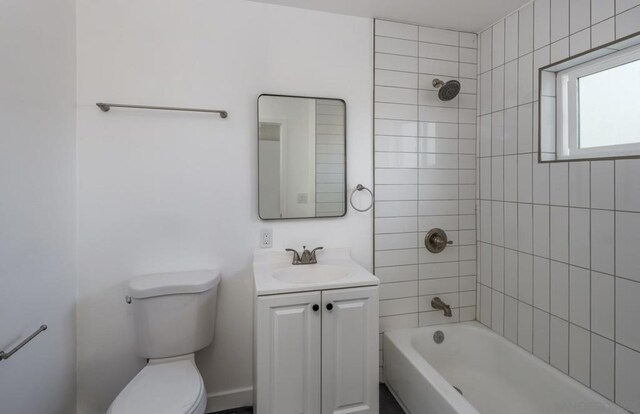 full bathroom with toilet, tiled shower / bath, and vanity