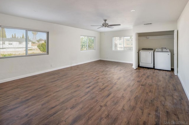 interior space featuring ceiling fan, dark hardwood / wood-style flooring, and washing machine and clothes dryer