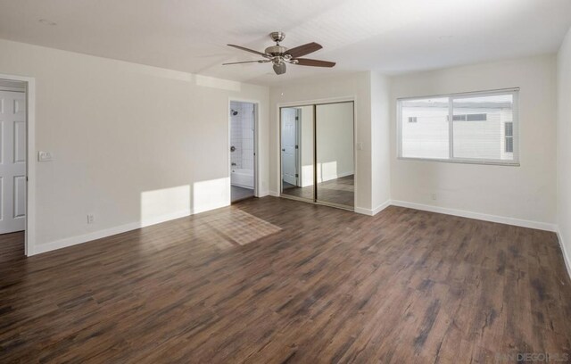 unfurnished bedroom with ceiling fan, dark hardwood / wood-style flooring, and connected bathroom