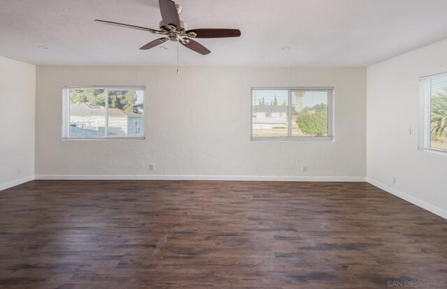 spare room with ceiling fan and dark hardwood / wood-style flooring