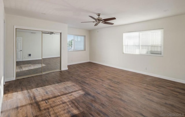 unfurnished bedroom featuring ceiling fan, a closet, and dark hardwood / wood-style floors