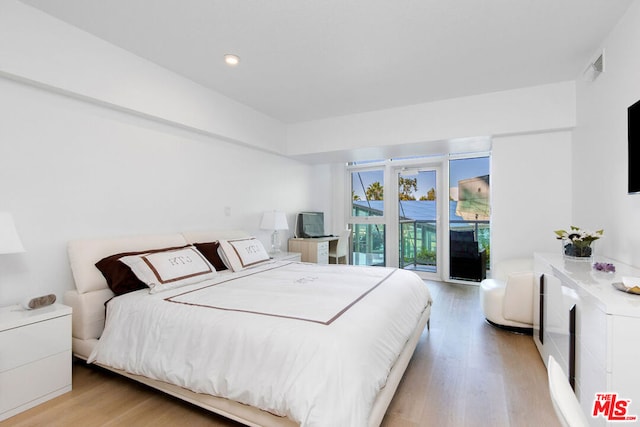 bedroom with light hardwood / wood-style floors and access to outside