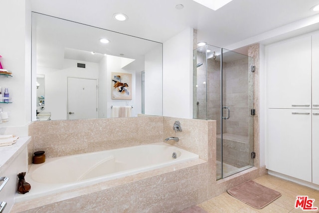 bathroom featuring vanity and shower with separate bathtub