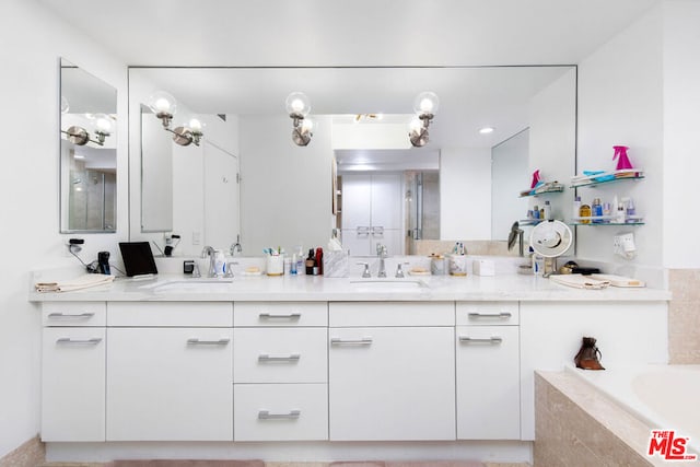 bathroom with tiled bath and vanity