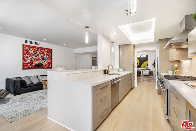 kitchen with hanging light fixtures, light hardwood / wood-style flooring, stainless steel appliances, and gray cabinetry