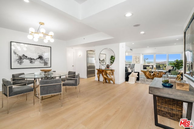 interior space featuring a chandelier and light hardwood / wood-style floors