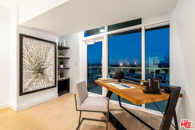 office space with hardwood / wood-style flooring and expansive windows