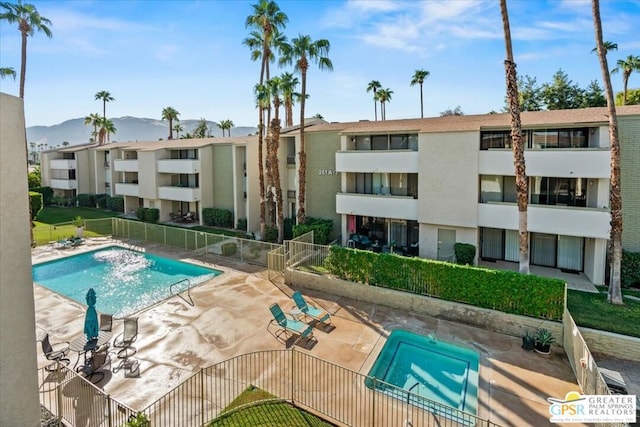 view of pool featuring a mountain view and a patio