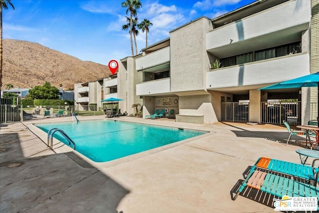 view of swimming pool with a mountain view