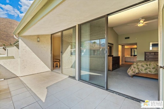 exterior space with ceiling fan and a patio area