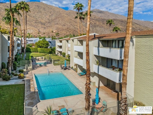 view of pool with a patio area and a mountain view