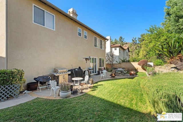 rear view of property with a patio area and a yard