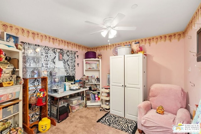 carpeted office space with ceiling fan