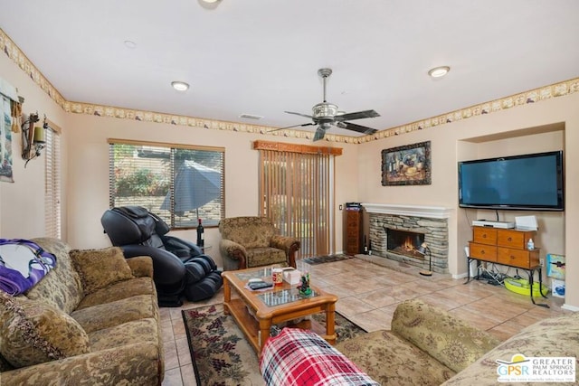 living room with ceiling fan, light tile patterned floors, and a fireplace