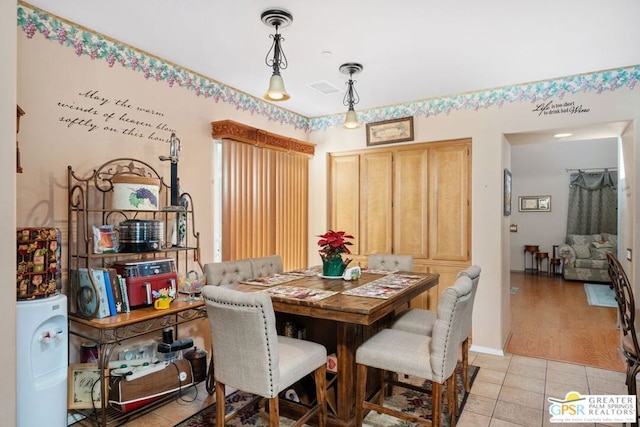 dining space featuring light tile patterned flooring