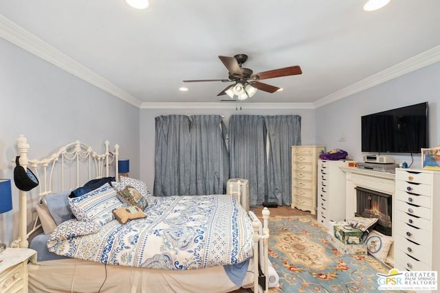 bedroom with ceiling fan and crown molding