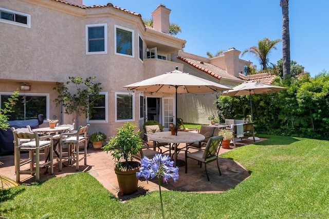 rear view of property with a patio area and a yard