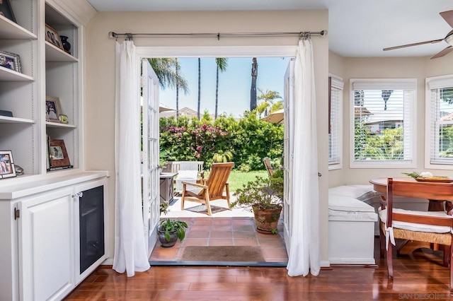 doorway to outside featuring ceiling fan, dark hardwood / wood-style floors, and a wealth of natural light