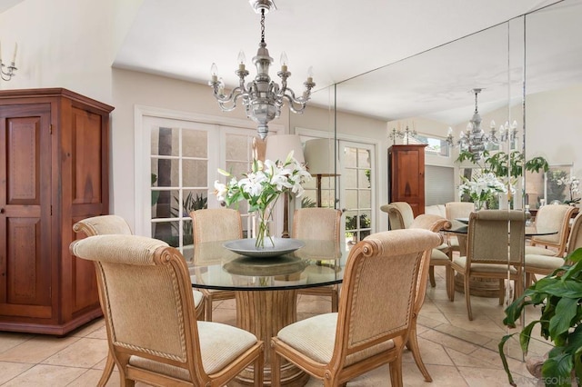 tiled dining space featuring vaulted ceiling, a chandelier, and french doors