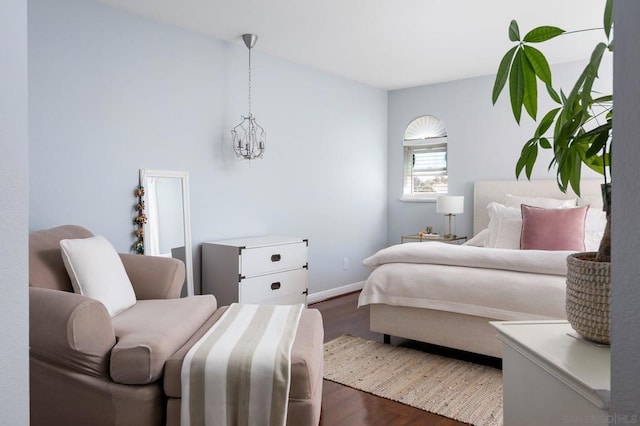 bedroom featuring dark wood-type flooring and a notable chandelier