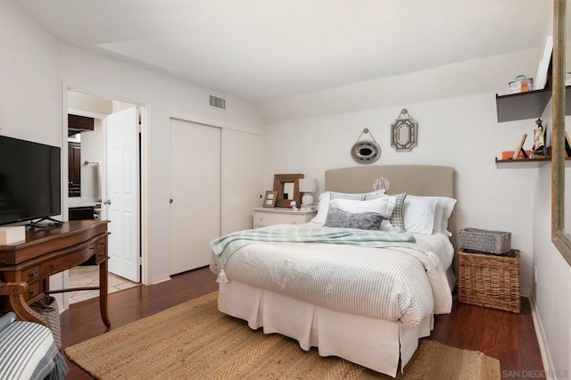 bedroom featuring dark hardwood / wood-style floors and a closet