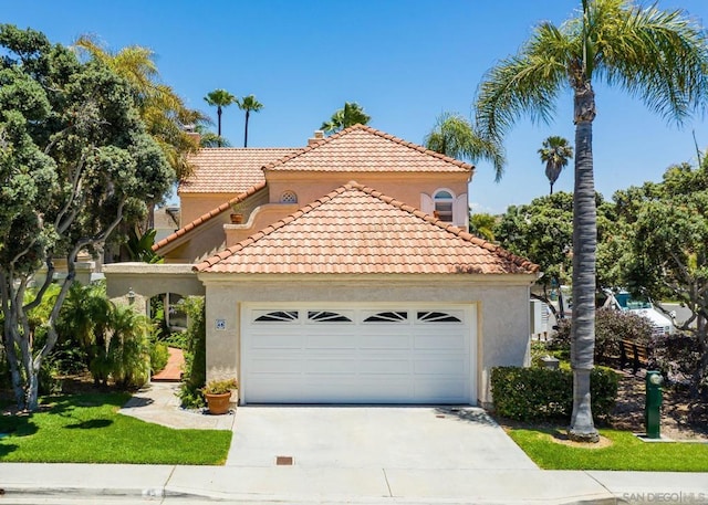 mediterranean / spanish-style home with a garage