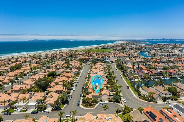 birds eye view of property featuring a beach view and a water view