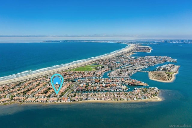 aerial view with a water view and a beach view