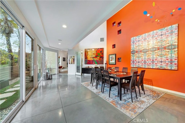 dining space featuring recessed lighting, visible vents, finished concrete floors, high vaulted ceiling, and baseboards