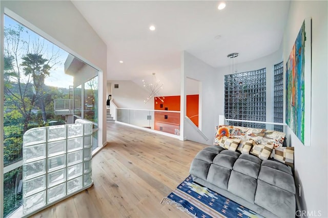 living area featuring an inviting chandelier, wood finished floors, and recessed lighting