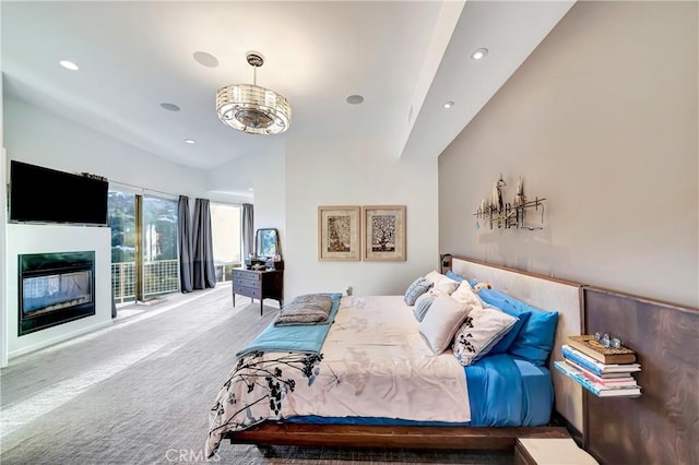 carpeted bedroom with recessed lighting and a glass covered fireplace