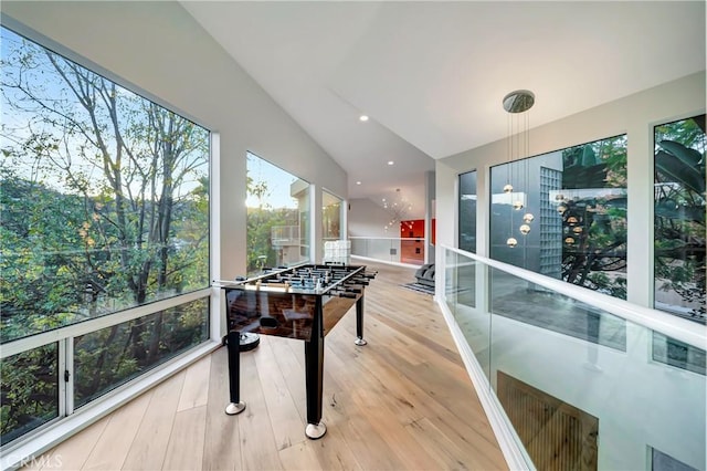 rec room featuring vaulted ceiling, wood finished floors, and recessed lighting