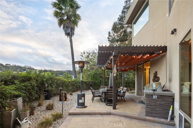 view of patio / terrace featuring outdoor dining space, a pergola, and area for grilling