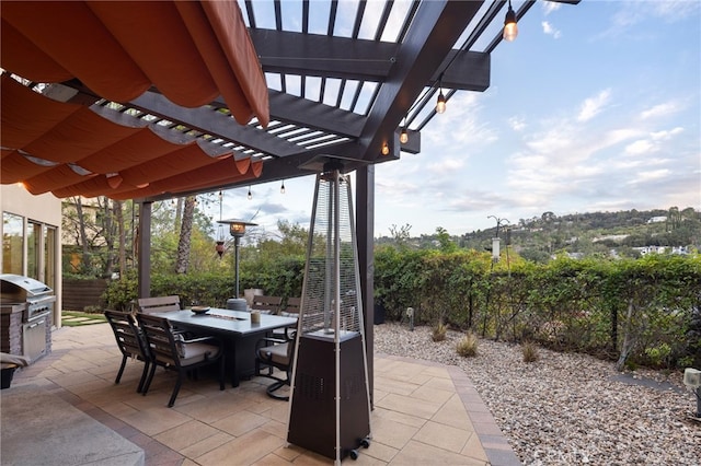 view of patio with outdoor dining area, a pergola, and area for grilling