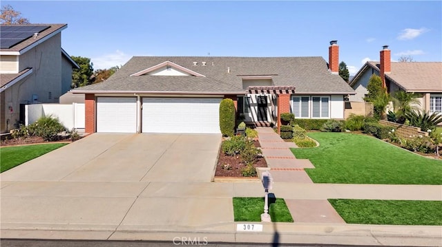 view of front of home with a front yard and a garage