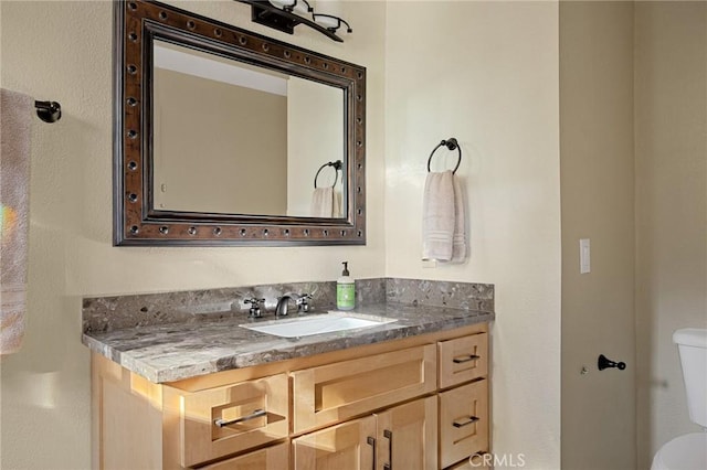 bathroom featuring toilet and vanity