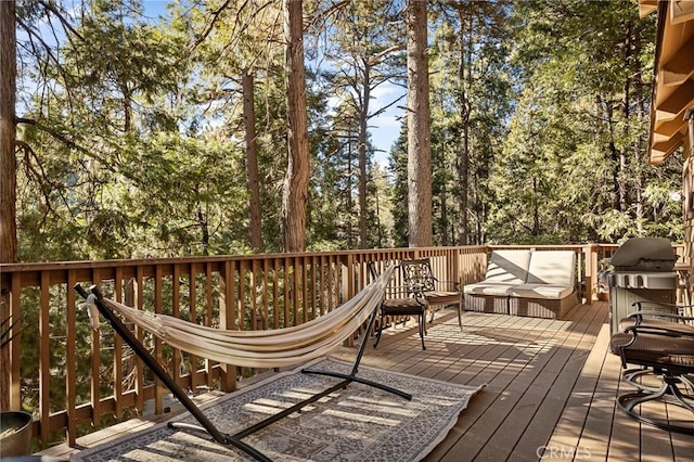 wooden deck featuring a grill