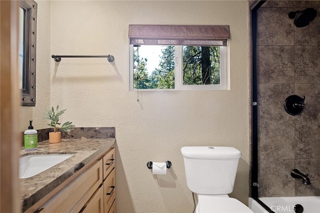 full bathroom with toilet, vanity, and tiled shower / bath combo