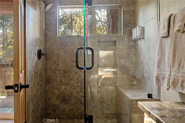 bathroom featuring a shower with door