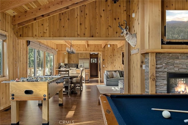 recreation room featuring a stone fireplace, wooden walls, dark hardwood / wood-style floors, billiards, and wooden ceiling