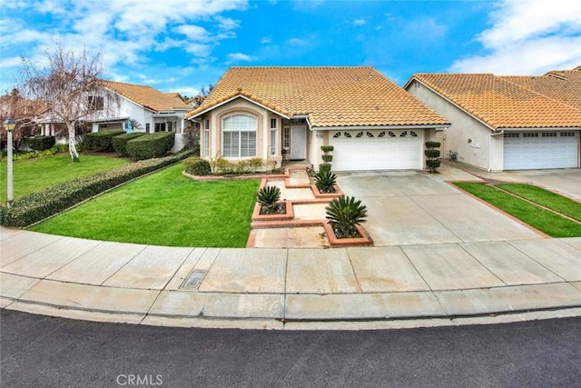 mediterranean / spanish-style house with a front yard and a garage