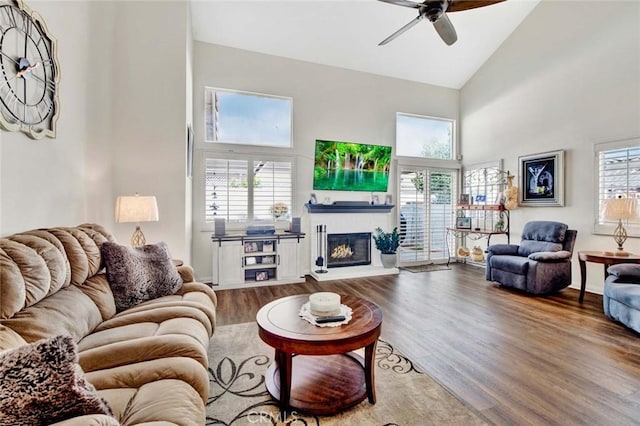 living room featuring high vaulted ceiling, ceiling fan, and hardwood / wood-style floors