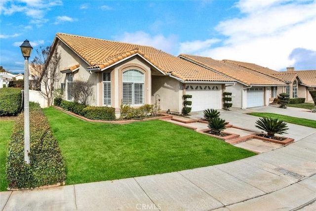 mediterranean / spanish-style house with a garage and a front yard