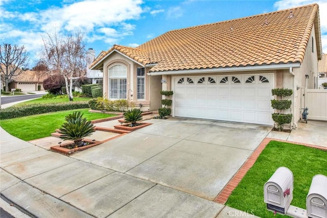 view of front of property featuring a front yard and a garage