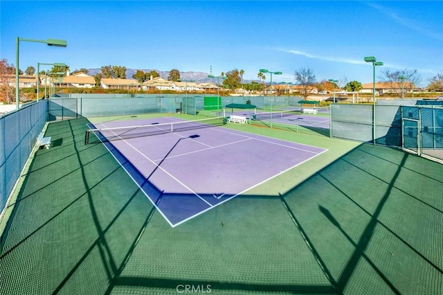 view of tennis court featuring basketball court