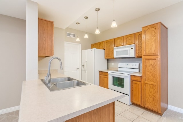 kitchen with sink, white appliances, light tile patterned floors, and hanging light fixtures