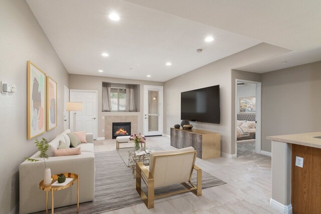 carpeted living room with a tiled fireplace