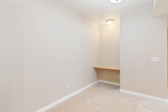 unfurnished room featuring light colored carpet