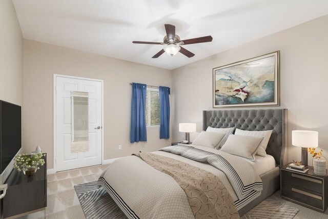 bedroom featuring ceiling fan and light carpet